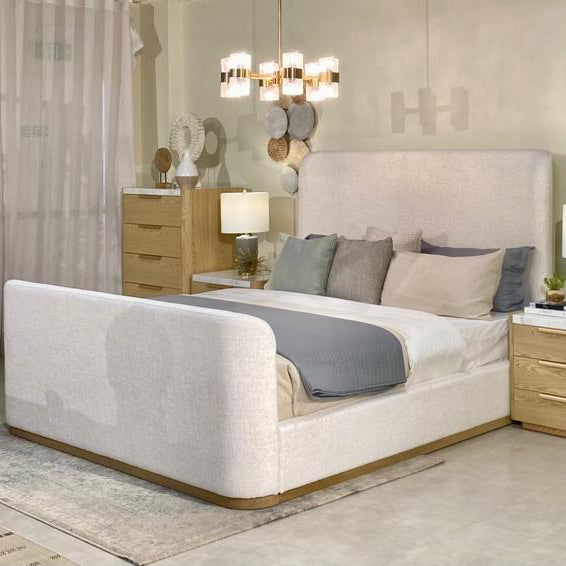 Modern bedroom with a large bed, nightstands, and wall art.