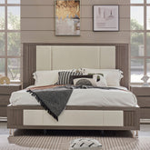 Modern bedroom with a bed, nightstands, and artwork on the wall.